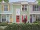 Colorful townhouses with unique doors and shutters, complemented by lush landscaping for curb appeal at 3308 W Wyoming Cir, Tampa, FL 33611