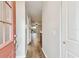 Inviting home hallway with hardwood floors, neutral walls, and a view of the living area at 3308 W Wyoming Cir, Tampa, FL 33611