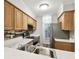 Well-lit kitchen with stainless steel appliances and light wood cabinets at 3308 W Wyoming Cir, Tampa, FL 33611