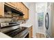 Well-equipped kitchen featuring stainless steel appliances and light wood cabinets at 3308 W Wyoming Cir, Tampa, FL 33611