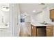 Kitchen area with view to the living space and access to the backyard at 3308 W Wyoming Cir, Tampa, FL 33611