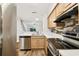 Modern kitchen features stainless steel appliances and an open view to the living area at 3308 W Wyoming Cir, Tampa, FL 33611