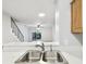 Open kitchen area with stainless steel sink and a clear view to the living area and backyard at 3308 W Wyoming Cir, Tampa, FL 33611