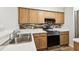 Bright kitchen features stainless steel appliances, light wood cabinets and stone countertops at 3308 W Wyoming Cir, Tampa, FL 33611