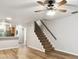 Inviting living room with warm wood-look floors that connects to the kitchen and stairway at 3308 W Wyoming Cir, Tampa, FL 33611