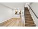 Spacious living room with wood-look floors, stairway, and open to the kitchen at 3308 W Wyoming Cir, Tampa, FL 33611