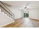 Light and bright living room with stairs, wood-look flooring, and sliding glass door at 3308 W Wyoming Cir, Tampa, FL 33611