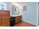 Bright bathroom featuring wood-look floors, single vanity, framed mirror, and natural light at 4537 Thornton Dr, Zephyrhills, FL 33542