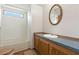 Compact bathroom with a bathtub, single vanity, mirror, and a small window providing natural light at 4537 Thornton Dr, Zephyrhills, FL 33542