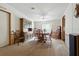Formal dining room with carpet, wood table and chairs, buffet, and light fixture at 4537 Thornton Dr, Zephyrhills, FL 33542