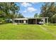 Charming home with lush front yard, covered parking, screened porch and shed at 4537 Thornton Dr, Zephyrhills, FL 33542