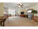 Open living room with a decorative fireplace and tv creating a focal point for relaxation and entertainment at 4537 Thornton Dr, Zephyrhills, FL 33542