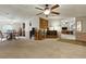 Spacious living room with ceiling fan, carpeted floor and classic decor offering a cozy atmosphere at 4537 Thornton Dr, Zephyrhills, FL 33542