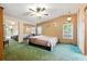 Spacious main bedroom with mirrored closet, ceiling fan, carpet, and two windows bringing in natural light at 4537 Thornton Dr, Zephyrhills, FL 33542
