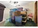 Organized storage room with various colored bins stacked, illuminated by a ceiling fan and lamp at 4537 Thornton Dr, Zephyrhills, FL 33542