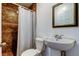 Cozy bathroom featuring tile in the shower and a decorative mirror at 4727 Town N Country Blvd, Tampa, FL 33615