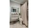 Updated bathroom with modern vanity, lighted mirror, and tiled shower with shower curtain at 4727 Town N Country Blvd, Tampa, FL 33615