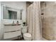 Updated bathroom with modern vanity, lighted mirror, and tiled shower with shower curtain at 4727 Town N Country Blvd, Tampa, FL 33615