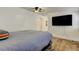 Large bedroom with hard wood floors and a tv on the wall at 4727 Town N Country Blvd, Tampa, FL 33615