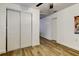 Spacious bedroom with wood floors, sliding closet doors, and white walls at 4727 Town N Country Blvd, Tampa, FL 33615
