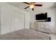 Bedroom features a ceiling fan, tv and a closet with sliding doors at 4727 Town N Country Blvd, Tampa, FL 33615