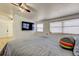 Bright bedroom featuring a ceiling fan, television, and natural light from a window at 4727 Town N Country Blvd, Tampa, FL 33615
