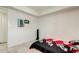 Simple bedroom with tile floors, minimalist decor, and a tower fan at 4727 Town N Country Blvd, Tampa, FL 33615