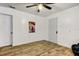 Bedroom features wood floors and a decorative movie poster on the wall at 4727 Town N Country Blvd, Tampa, FL 33615