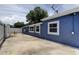 Exterior of the home showing the patio area and a modern paint job at 4727 Town N Country Blvd, Tampa, FL 33615