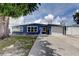 Exterior of a home with an attached garage, a driveway, and a well-maintained lawn at 4727 Town N Country Blvd, Tampa, FL 33615