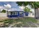 Exterior of the home showcasing the siding, windows, and a well-maintained lawn at 4727 Town N Country Blvd, Tampa, FL 33615