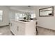 Bright kitchen featuring a center island, stainless steel appliances, white cabinets, and modern finishes at 4727 Town N Country Blvd, Tampa, FL 33615