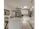 Bright kitchen featuring a center island, stainless steel appliances, white cabinets, and modern finishes at 4727 Town N Country Blvd, Tampa, FL 33615
