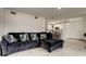 Living room featuring tile floors, a view into the kitchen, and contemporary furnishings at 4727 Town N Country Blvd, Tampa, FL 33615