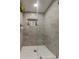 Modern shower with glass enclosure, tile, and storage at 4727 Town N Country Blvd, Tampa, FL 33615