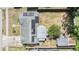 Aerial view of home highlighting solar panels, backyard shed, fenced yard and convenient neighborhood location at 5414 Oceanic Rd, Holiday, FL 34690