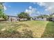 Expansive backyard featuring well-maintained lawn, a storage shed, and plenty of space for outdoor activities at 5414 Oceanic Rd, Holiday, FL 34690
