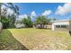Large backyard featuring lush lawn, a storage shed, and mature trees offering shade and privacy at 5414 Oceanic Rd, Holiday, FL 34690