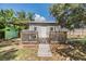 Detached backyard shed with a small deck and ramp access; offering additional storage or workshop space at 5414 Oceanic Rd, Holiday, FL 34690