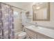 Clean bathroom featuring a shower and tub combination and a mirrored vanity at 5414 Oceanic Rd, Holiday, FL 34690
