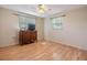 Bedroom with hardwood floors, ceiling fan, and plenty of natural light at 5414 Oceanic Rd, Holiday, FL 34690
