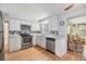 Bright kitchen with white cabinetry, stainless steel appliances, and hardwood floors at 5414 Oceanic Rd, Holiday, FL 34690