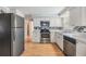 Modern kitchen with stainless steel appliances, granite countertops, and tiled backsplash at 5414 Oceanic Rd, Holiday, FL 34690