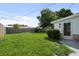 A private backyard, surrounded by a wood fence and lush grass, offering an enjoyable green space at 5627 57Th N Ave, St Petersburg, FL 33709