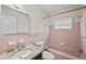 Bathroom featuring pink tile, granite countertop and vanity with shower and tub at 5627 57Th N Ave, St Petersburg, FL 33709