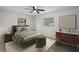 Virtually staged bedroom features a queen bed and art and side tables at 5627 57Th N Ave, St Petersburg, FL 33709