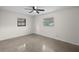 Bright bedroom features a ceiling fan, window and neutral color palette at 5627 57Th N Ave, St Petersburg, FL 33709