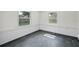 The Bonus Room features ample natural light, brick accents, and modern dark gray flooring at 5627 57Th N Ave, St Petersburg, FL 33709