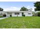 Charming single-story home with fresh exterior paint, a well-maintained lawn, and carport at 5627 57Th N Ave, St Petersburg, FL 33709
