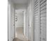 Hallway with neutral tones, white walls, closet with louvered doors, and great natural lighting at 5627 57Th N Ave, St Petersburg, FL 33709
